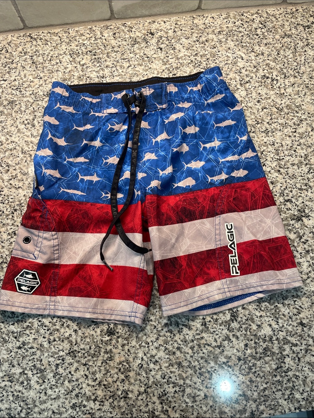 Pelagic boys Red, White & Blue Shark-Print Swim Trunks.